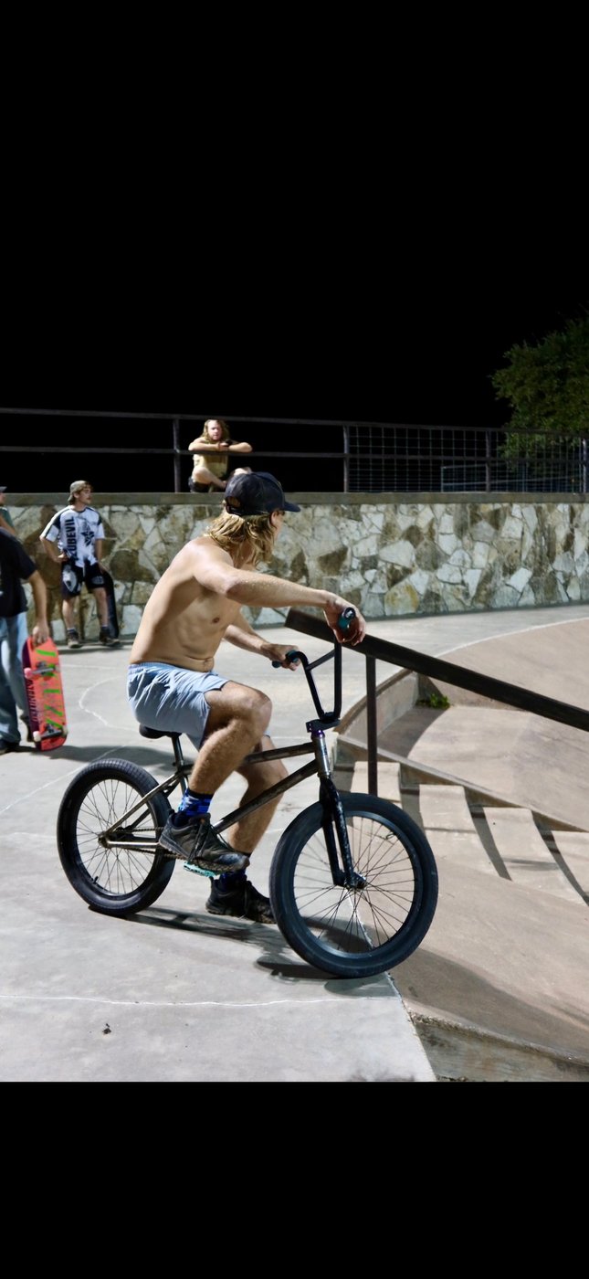 Joe on BMX at the skatepark at night